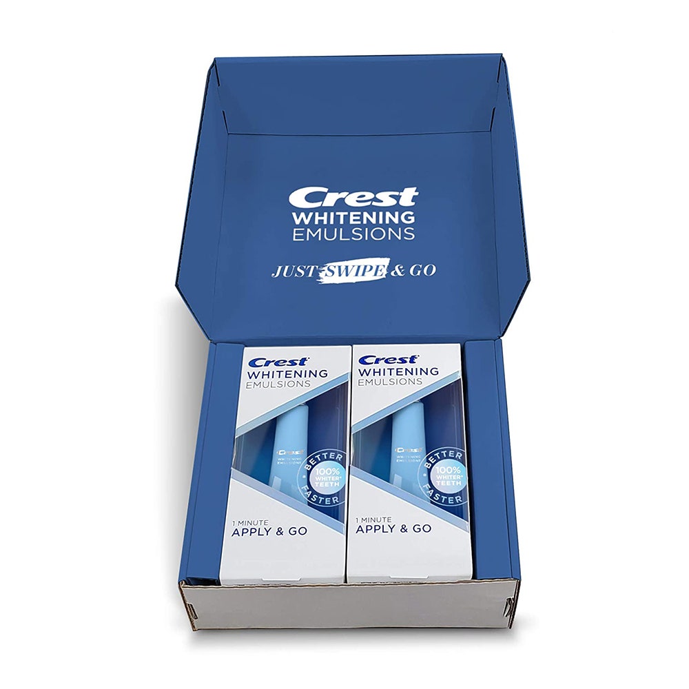 An open box of Crest Whitening Emulsions with Built-in Applicator (Twin Pack) on white background